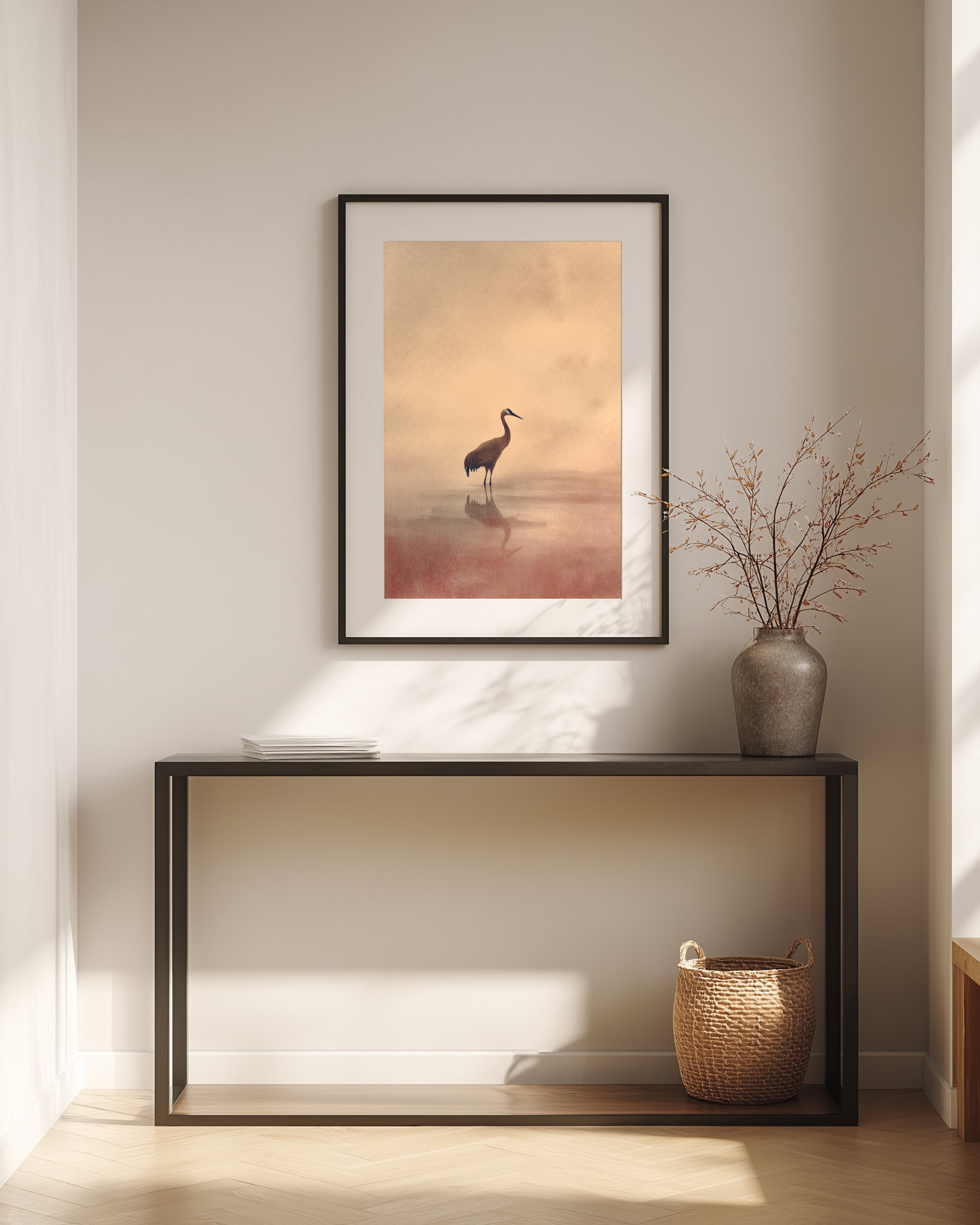 Ink crane painting framed above a console table